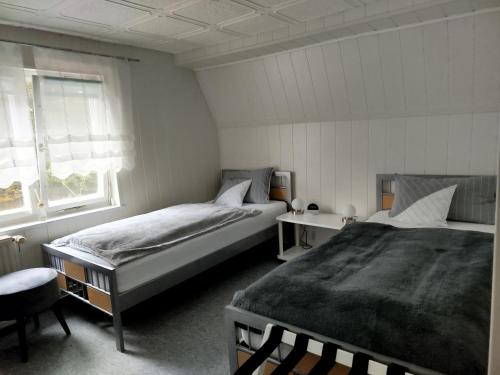 a bedroom with two beds and a table and a window at Stara Brožnja eGbR in Burg