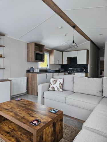 a living room with a couch and a table at Billing Aquadrome Holiday Park with Fishing Lakes in Great Billing