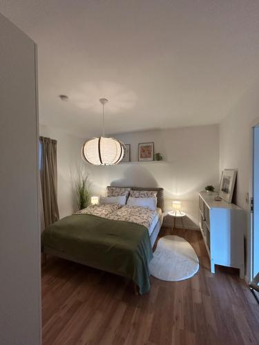 a bedroom with a bed and a table and a lamp at Ferienwohnung Bergische Auszeit in Gummersbach