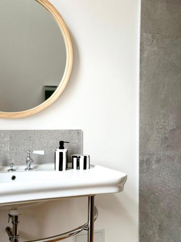 a bathroom with a sink and a mirror at Halluin Marthe Nollet in Halluin