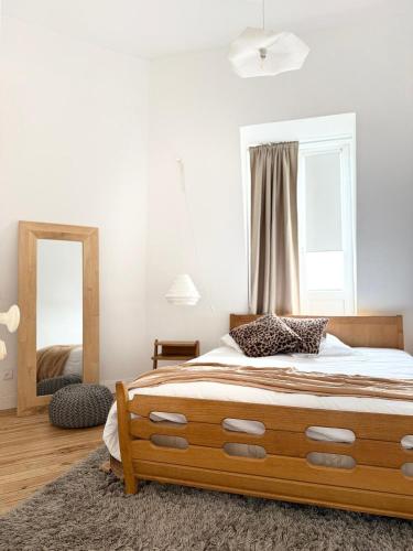 a bedroom with a large bed and a mirror at Halluin Marthe Nollet in Halluin
