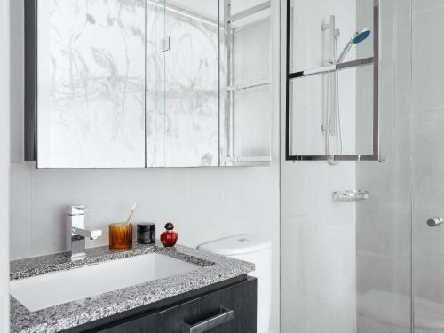 a bathroom with a sink and a shower at The Olsen Melbourne Art Series in Melbourne