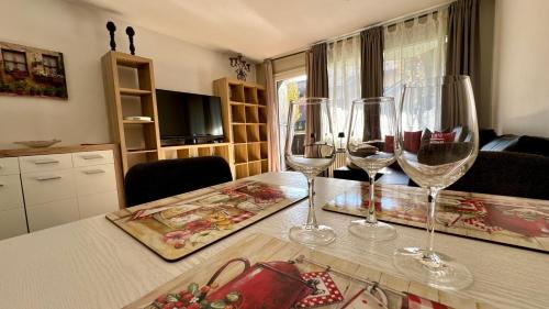 three wine glasses sitting on a table in a kitchen at Lindenhof Apartment 13 in Bad Aibling