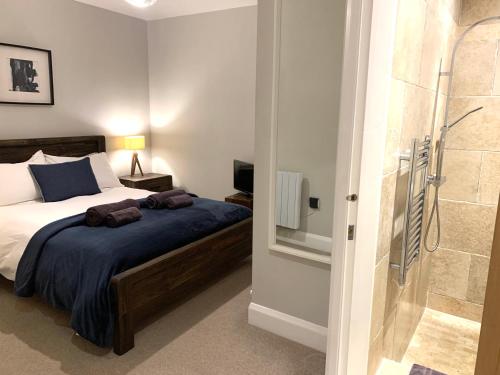 a bedroom with a bed and a walk in shower at 89a Church Street - Luxury One Bed Apartment with Roof Terrace in Whitby