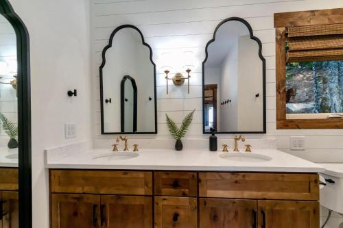a bathroom with two sinks and two mirrors at Beech Blessings in Beech Mountain