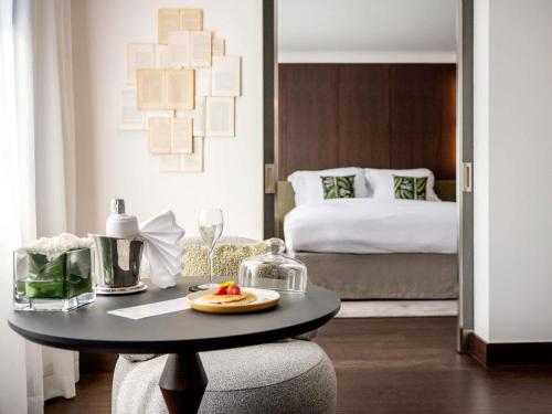 a room with a table with a plate of fruit on it at Le Louise Hotel Brussels - MGallery Collection in Brussels