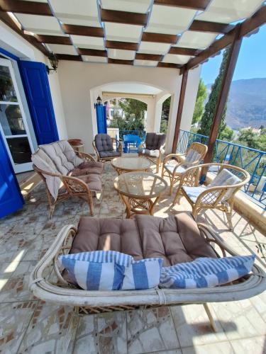 a living room with a couch and chairs at Villa Thea Kalymnos with swimming pool and sea view in Panormos Kalymnos