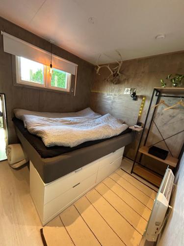 a bed in a room with a window at Lillahuset in Sundsvall