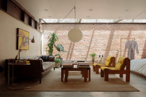 a living room with a couch and a table at Mane & Saddle Loft in Los Angeles