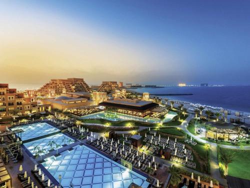 an aerial view of a resort with a swimming pool at Rixos Bab Al Bahr - Ultra All Inclusive in Ras al Khaimah
