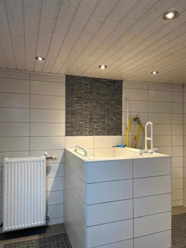 a bathroom with a sink and a radiator at Ferienwohnung Bergische Auszeit in Gummersbach