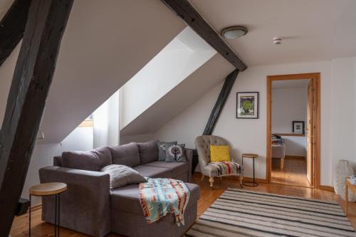 a living room with a couch and a chair at Kåseberga Hideout in Kåseberga