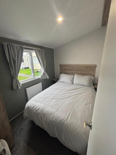 a bedroom with a large bed and a window at A&l by the sea in Fleetwood