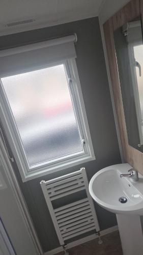 a bathroom with a window and a sink at A&l by the sea in Fleetwood