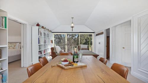 a dining room with a wooden table and chairs at Southern Grace in Bowral