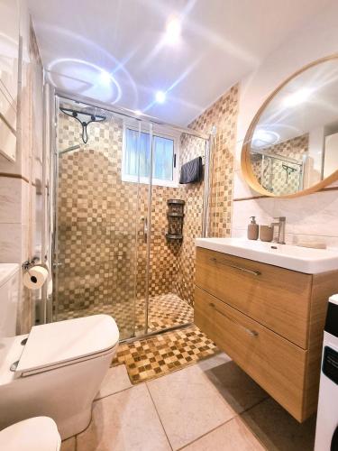 a bathroom with a shower and a toilet and a sink at Buena Vista Yaco See View Pool 2 Bedrooms in San Isidro