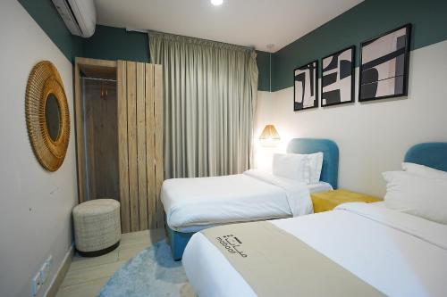 a hotel room with two beds in a room at Mabaat-White Pearl Compound 600 D Villa 23 in Jeddah