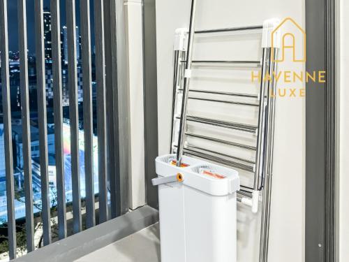 a white toilet in a room with a building at City Luxe Condo 5-Min Walk to Siam Paragon Modern Stay in Pratunam