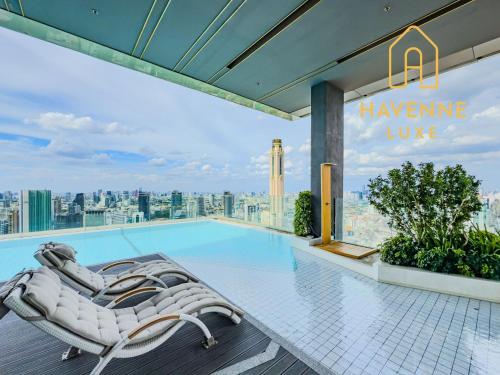 a hotel swimming pool with a view of the city at City Luxe Condo 5-Min Walk to Siam Paragon Modern Stay in Bangkok
