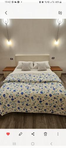 a bedroom with a large bed with blue flowers at La dimora di Gabi in Venice