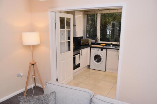 a kitchen with a washer and dryer in a room at Barnsley Town Centre Apartment in Barnsley