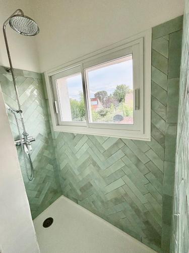 a bathroom with a shower and a window at Nana Bloo in La Teste-de-Buch