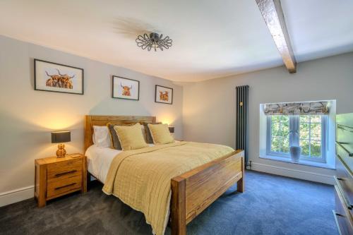 a bedroom with a bed and a window at Goytre Hall Self Catering Guest Accommodation in Abergavenny