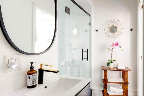 a bathroom with a large mirror and a white tub at Vibe on the Patio at a Modern Luxury Studio near LAX Beach in Los Angeles
