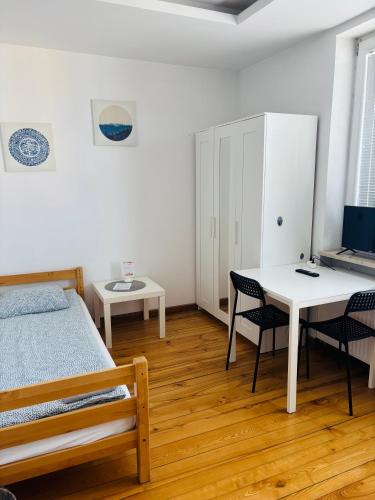 a bedroom with a bed and a table and chairs at Pokoje Slawin in Lublin