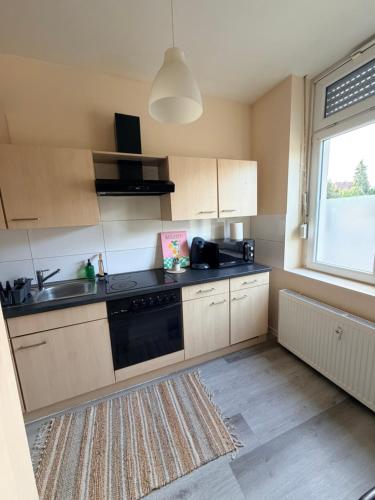 a kitchen with a sink and a stove top oven at Loft Riva in Hamm