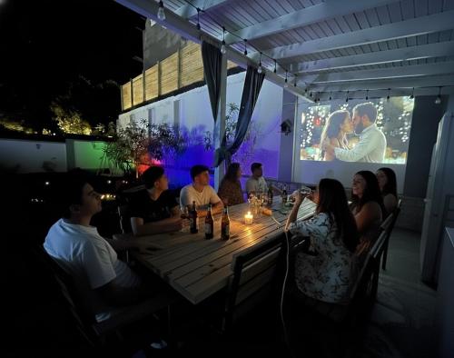 a group of people sitting around a wooden table at Qafqaz Mountside Chalet in Gabala