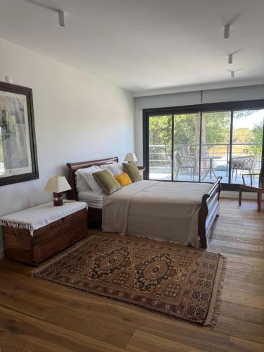 a bedroom with two beds and a large window at Urla Villa in Urla