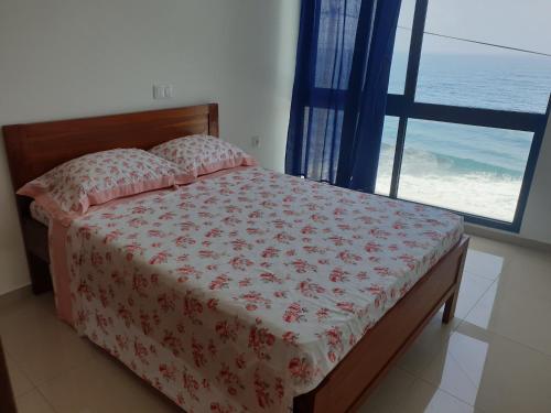 a bedroom with a bed with a view of the ocean at Casa Nova in Ribeira Grande