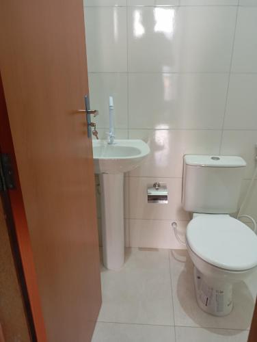 a bathroom with a toilet and a sink at hotel pousada Maanaim in Palmas