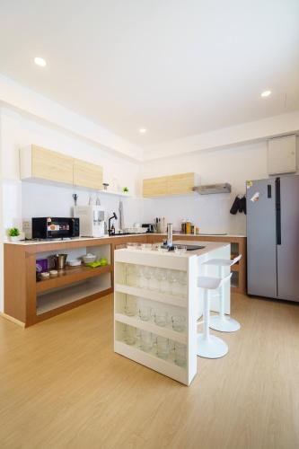 a kitchen with a counter and a refrigerator at 4BR Pool Villa Sukhum in Phuket Town in Changwat Phuket
