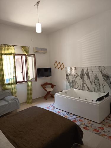 a bathroom with a bath tub in a room at casa colombo in Balestrate