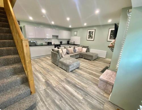 a living room with a couch and a kitchen at New Cosy three bedroom house in Ballingarry Limerick Near Adare in Limerick