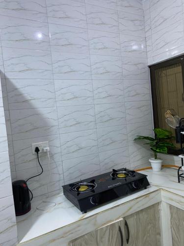 a kitchen with a stove on top of a counter at Casa Bellah Sunrise in Watamu