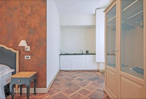 a room with a bed and a table and a sink at SUYTE Torino Centro in Turin