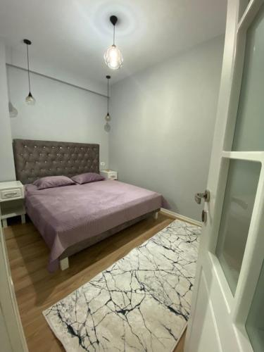 a bedroom with a bed and a rug at One Bedroom Apartment Lake View Pogradec in Pogradec