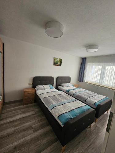 a bedroom with two beds in a room at Ferienwohnung Erna in Marktoberdorf