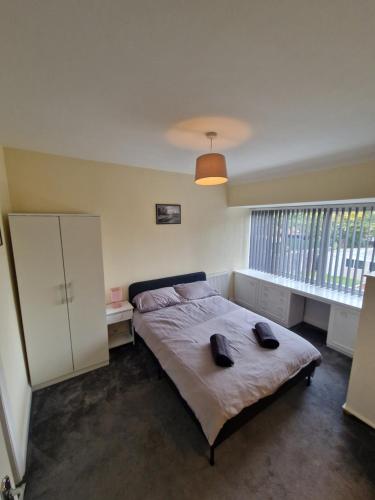 a bedroom with a bed and a large window at Sheldon Apartments BHX HS2 JLR NEC in Birmingham