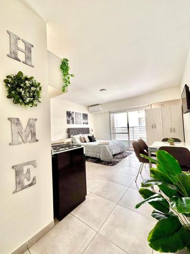 a bedroom with a bed and a living room at Loft Moderno - Natural - Rio in Rosario