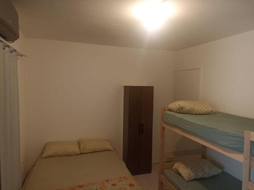 a bedroom with two bunk beds and a cabinet at Bella house in Balneário Camboriú