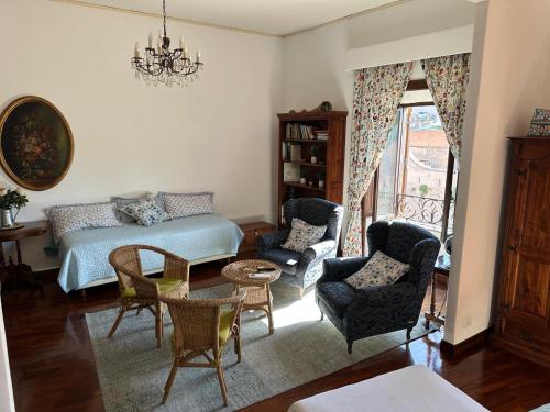 a bedroom with a bed and chairs and a table at Catherine's Home in Rome