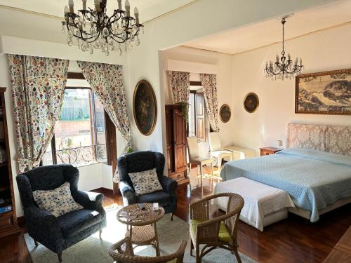 a bedroom with a bed and two chairs at Catherine's Home in Rome