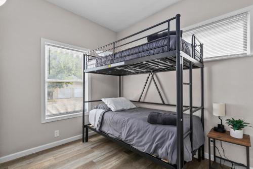 a bedroom with a bunk bed and a window at Central Oshkosh Stay - Walk to Lake and Downtown in Oshkosh
