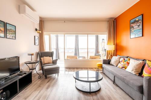 a living room with a couch and a table at Amazing Sea View Apt with Pool Cascais - atjoanas in Cascais