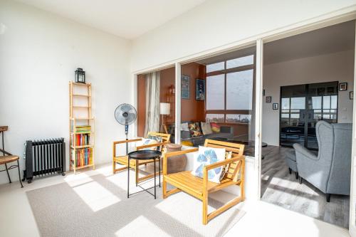 a living room with a table and chairs at Amazing Sea View Apt with Pool Cascais - atjoanas in Cascais