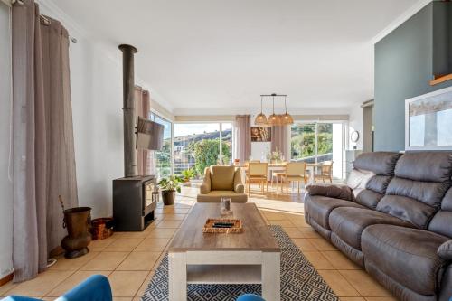 a living room with a couch and a table at Magnolia Sunsets in Calheta